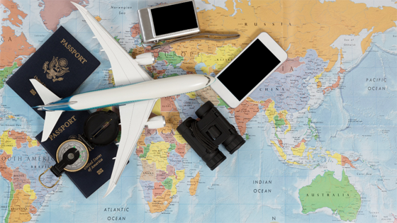 Image showing a plane, a map, and various other travel-related items